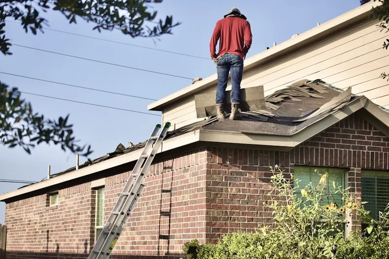 Professional roofer working on a residential roof in Albertville